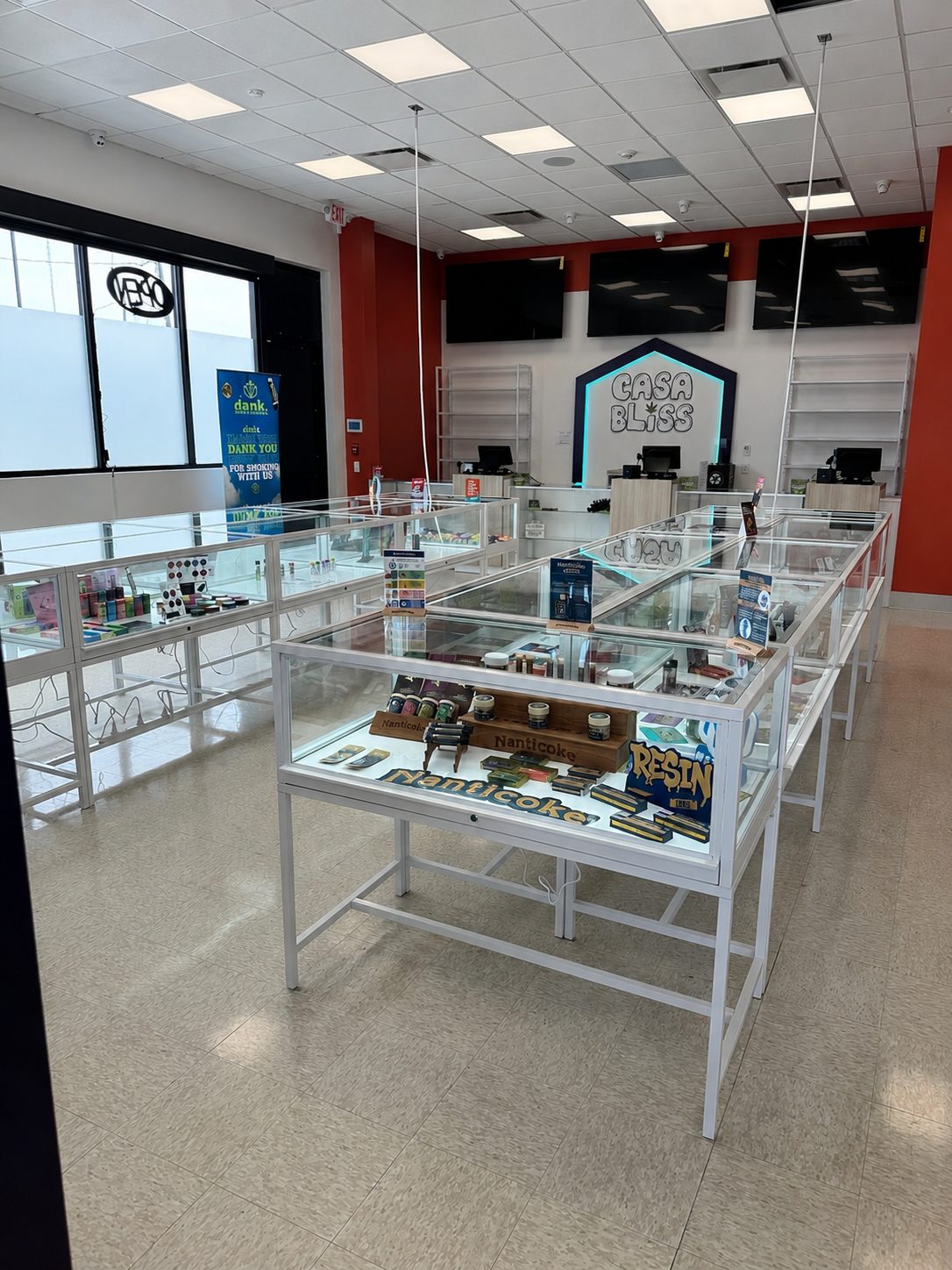 The Casa Bliss sales floor with display cases and orange accent walls